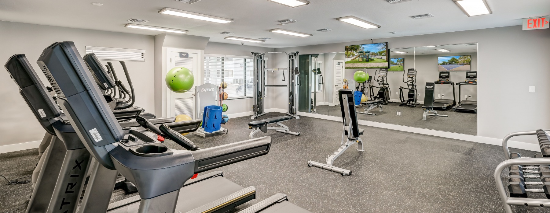 Fitness center with treadmills and weight benches
