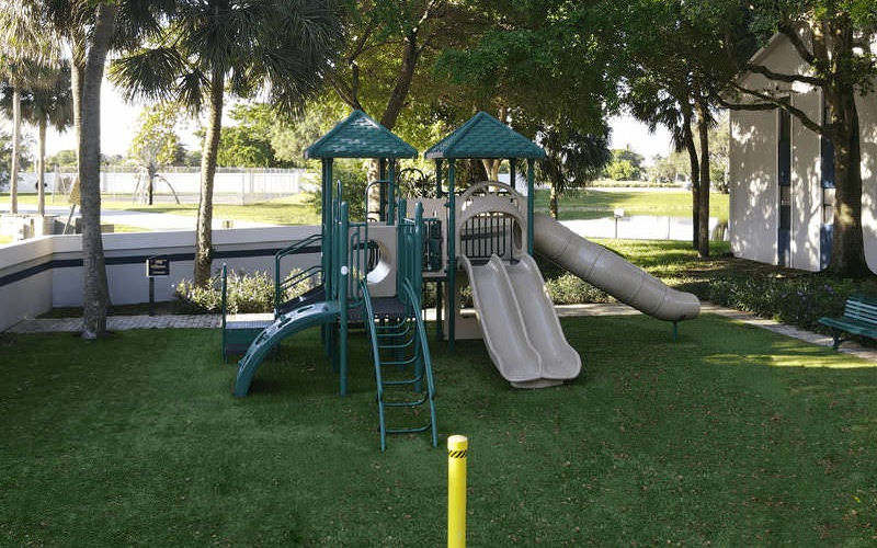 outdoor playground with tree shaded bench