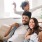 young family of three on living room couch