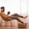 resident sits in a chair while listening to music on his headphones